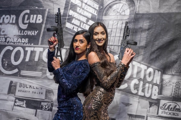 Two girls posing with guns