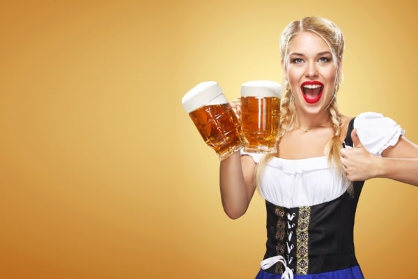 Women holding two jugs of beer